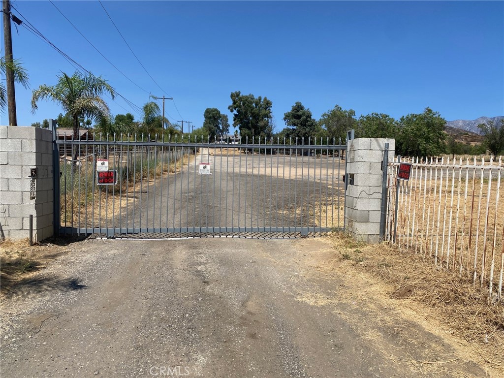 a view of a pathway with a wrought fence