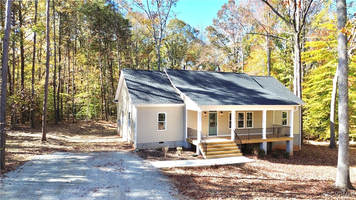 a front view of a house with a tree