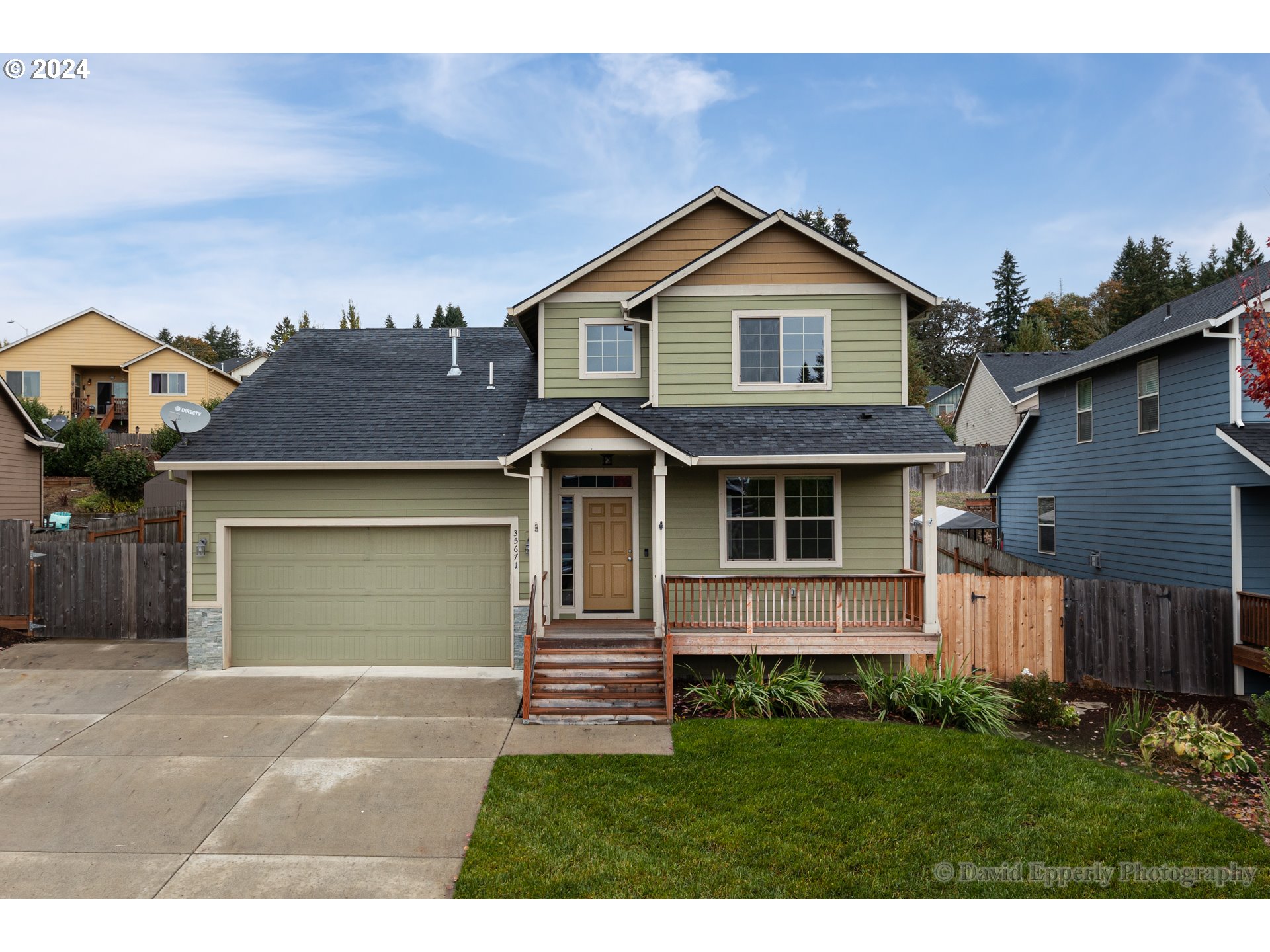 a front view of a house with a yard and garage