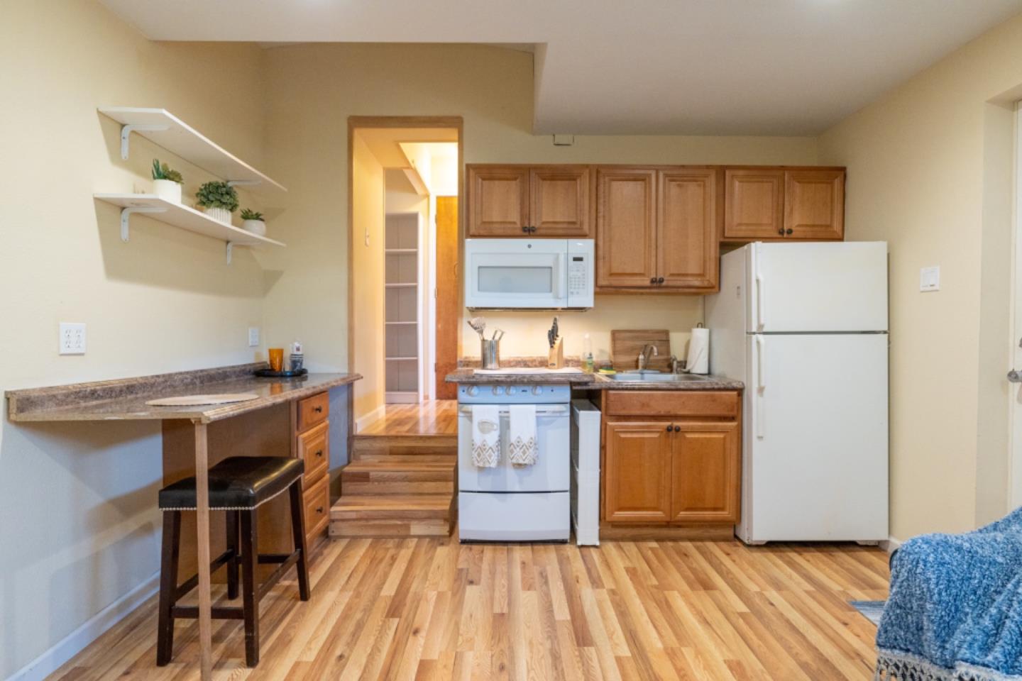 a kitchen with a refrigerator and a stove top oven