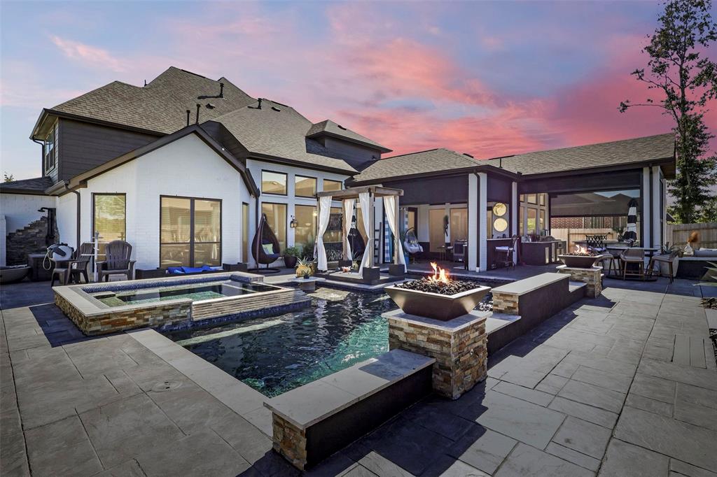 a view of a house with swimming pool and sitting area