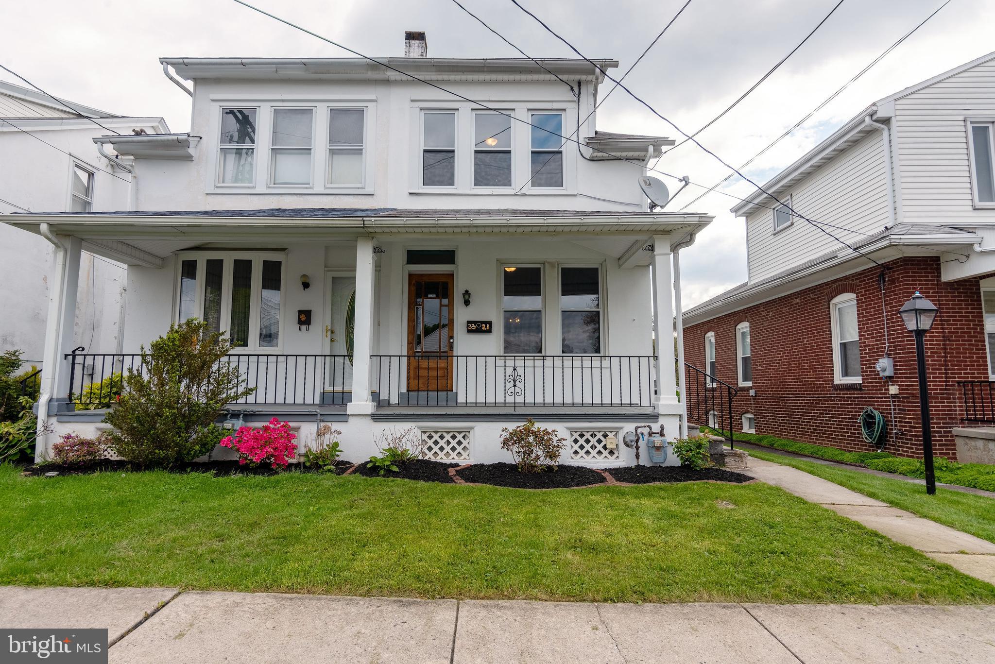 a front view of a house with garden