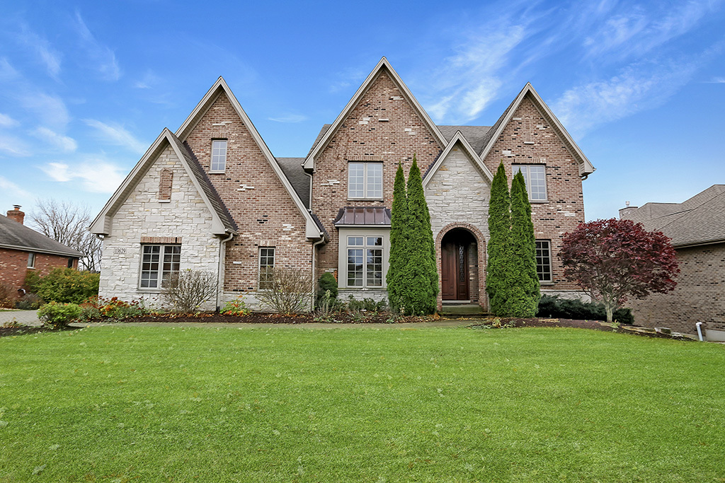 a front view of house with yard and green space