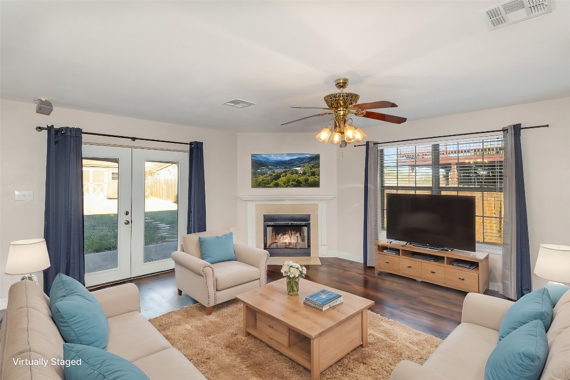 a living room with fireplace furniture and a flat screen tv