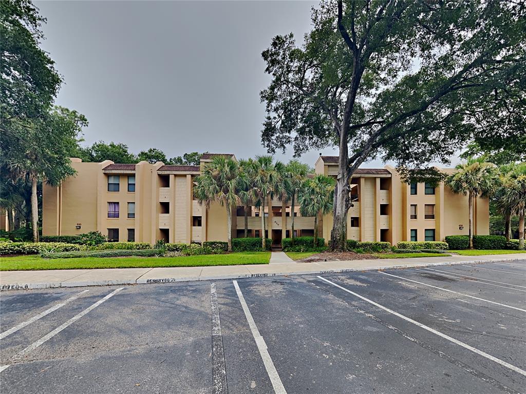 a front view of a building with trees