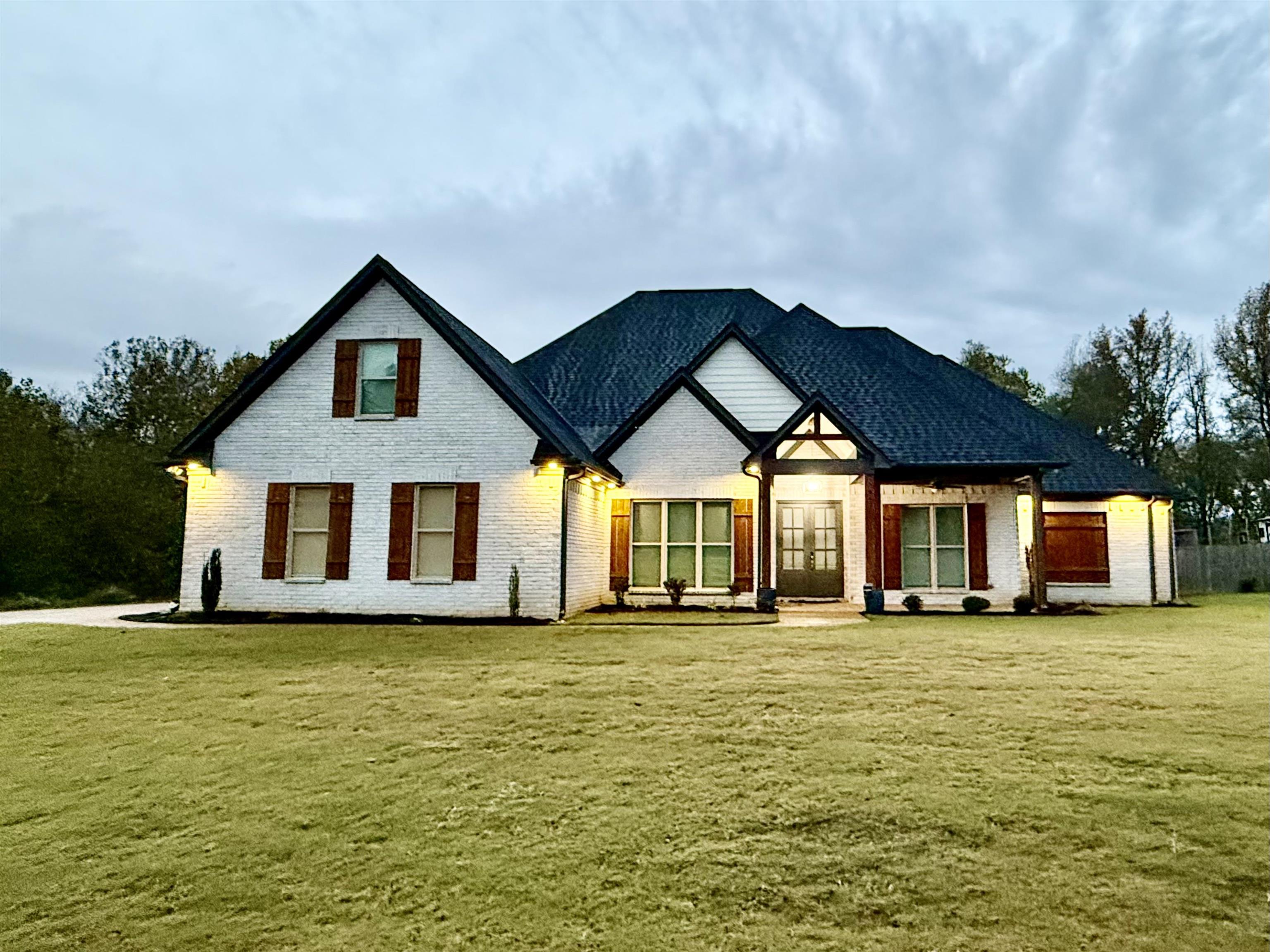 a big house with large trees in front of it