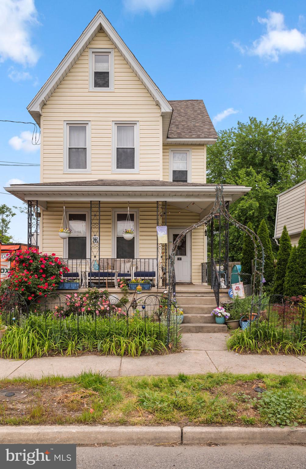 a front view of a house with garden and porch