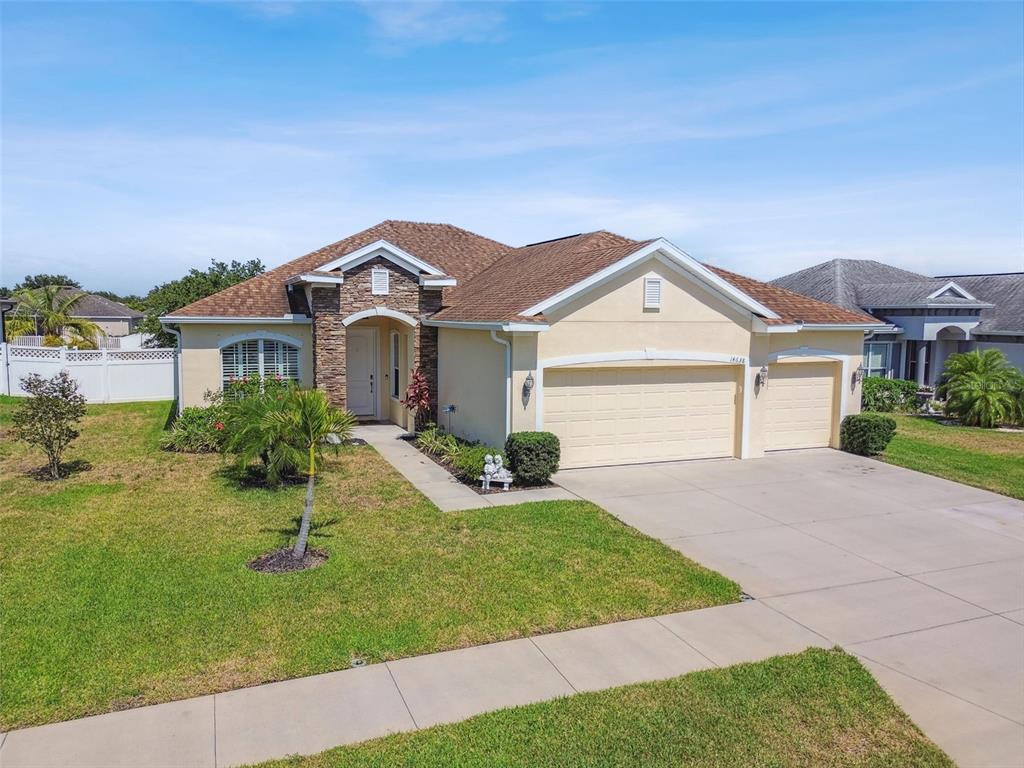 a front view of a house with a yard and garage