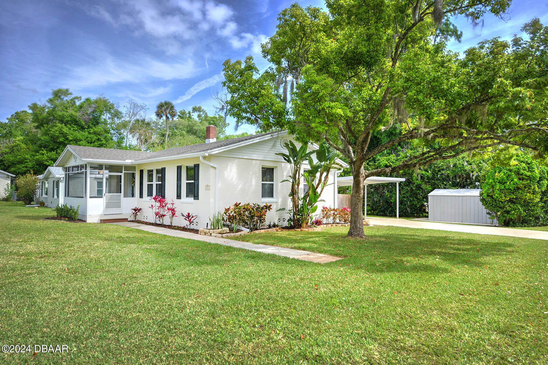 a front view of house with yard outdoor seating and green space