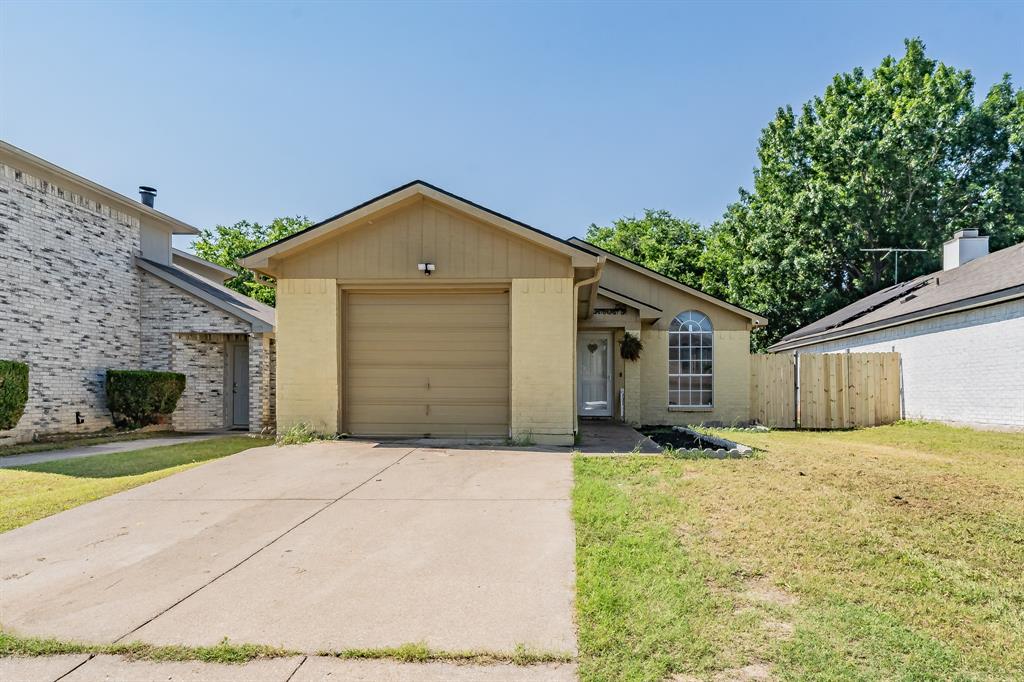 a front view of a house with yard and garage