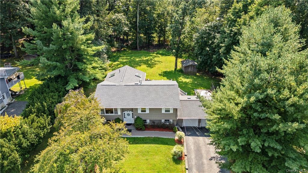 an aerial view of a house with swimming pool and garden