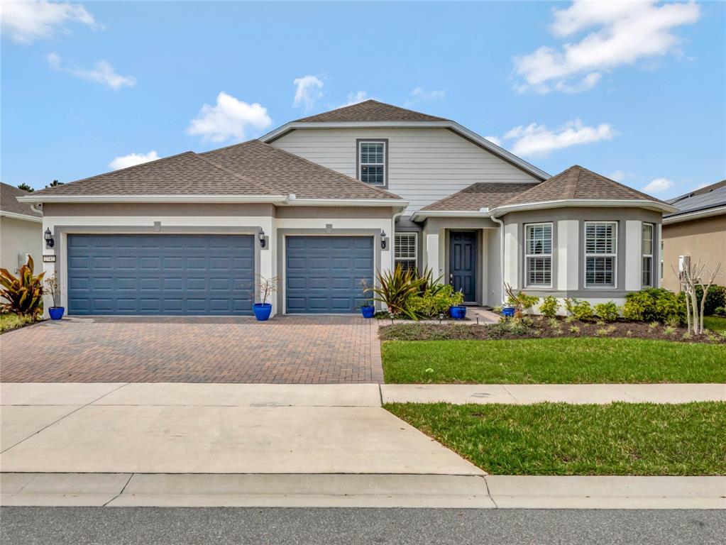 a front view of a house with a yard and garage