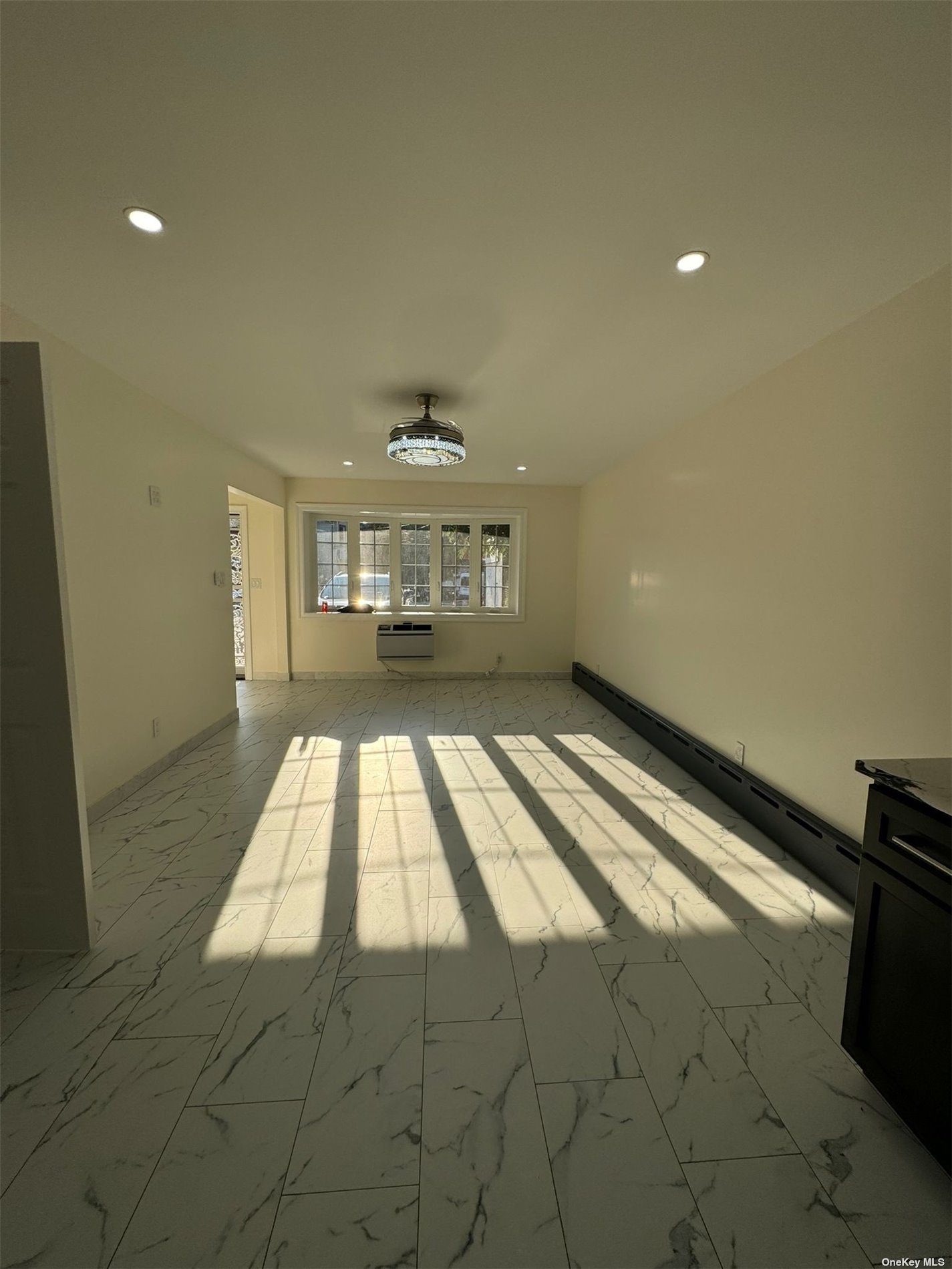 a view of an empty room and a window