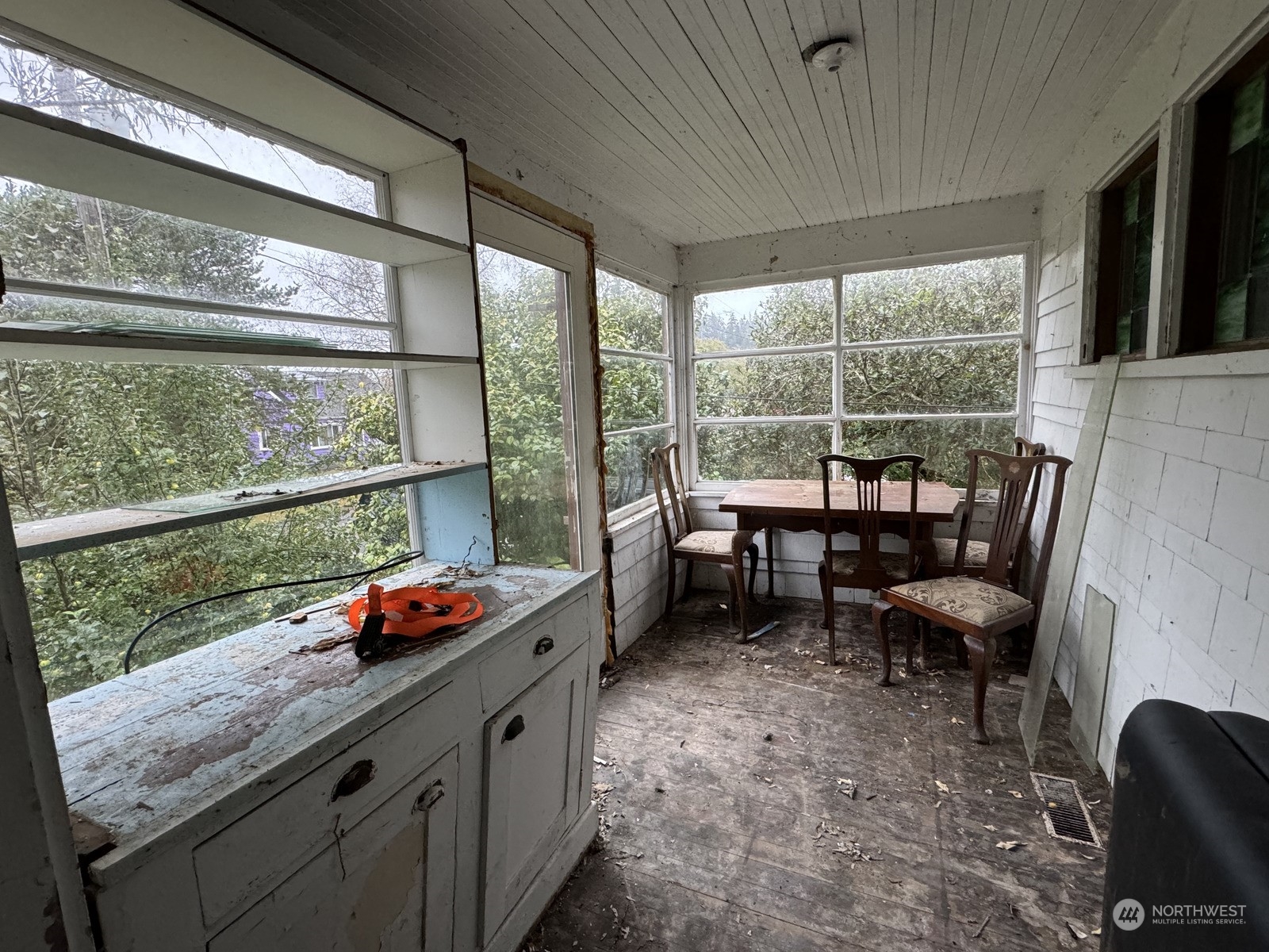 a dining room with furniture and a large window