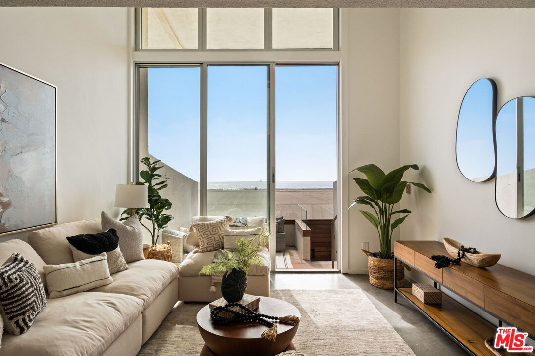 a living room with furniture and a potted plant