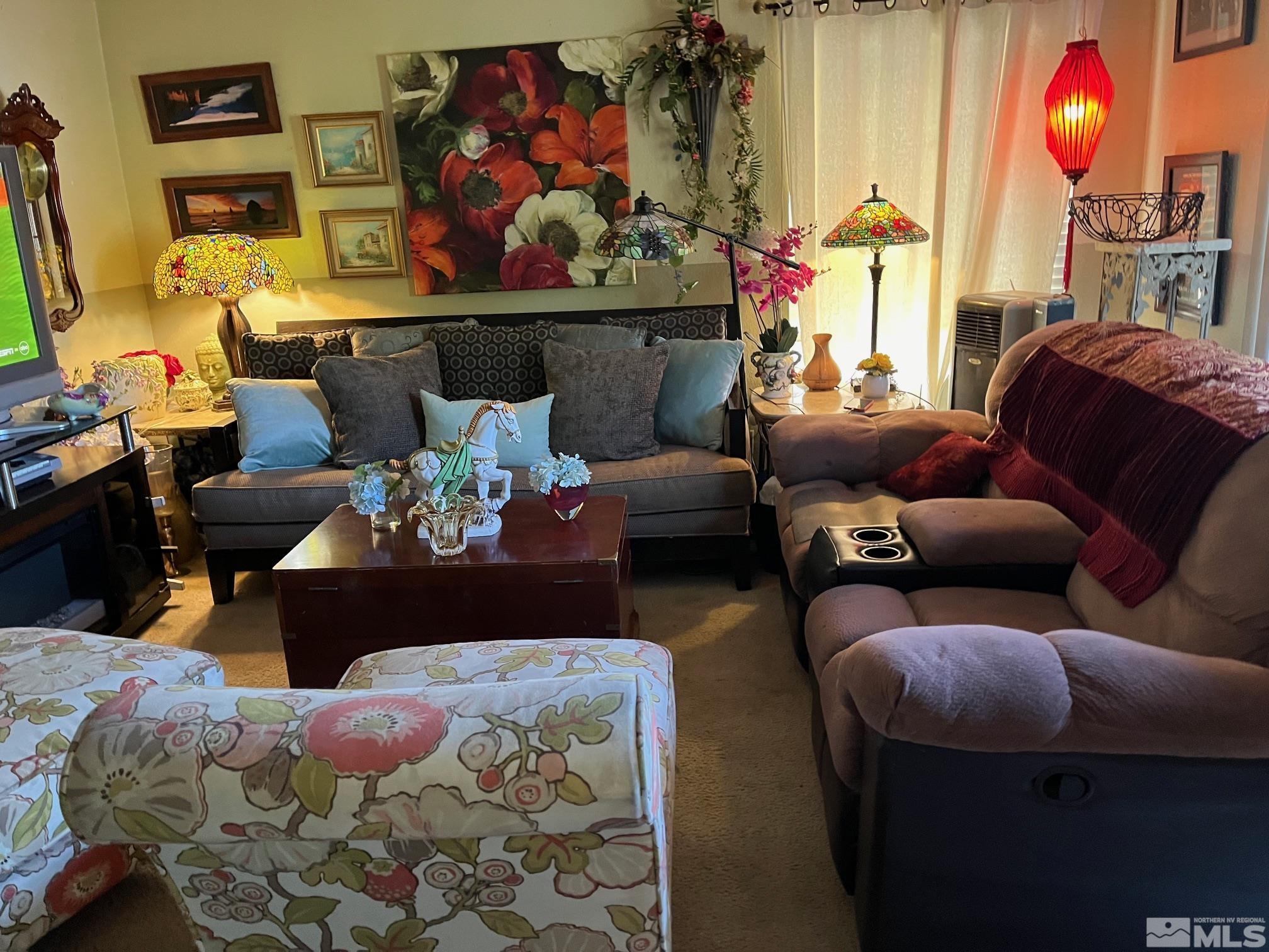 a living room with furniture and painting on the wall