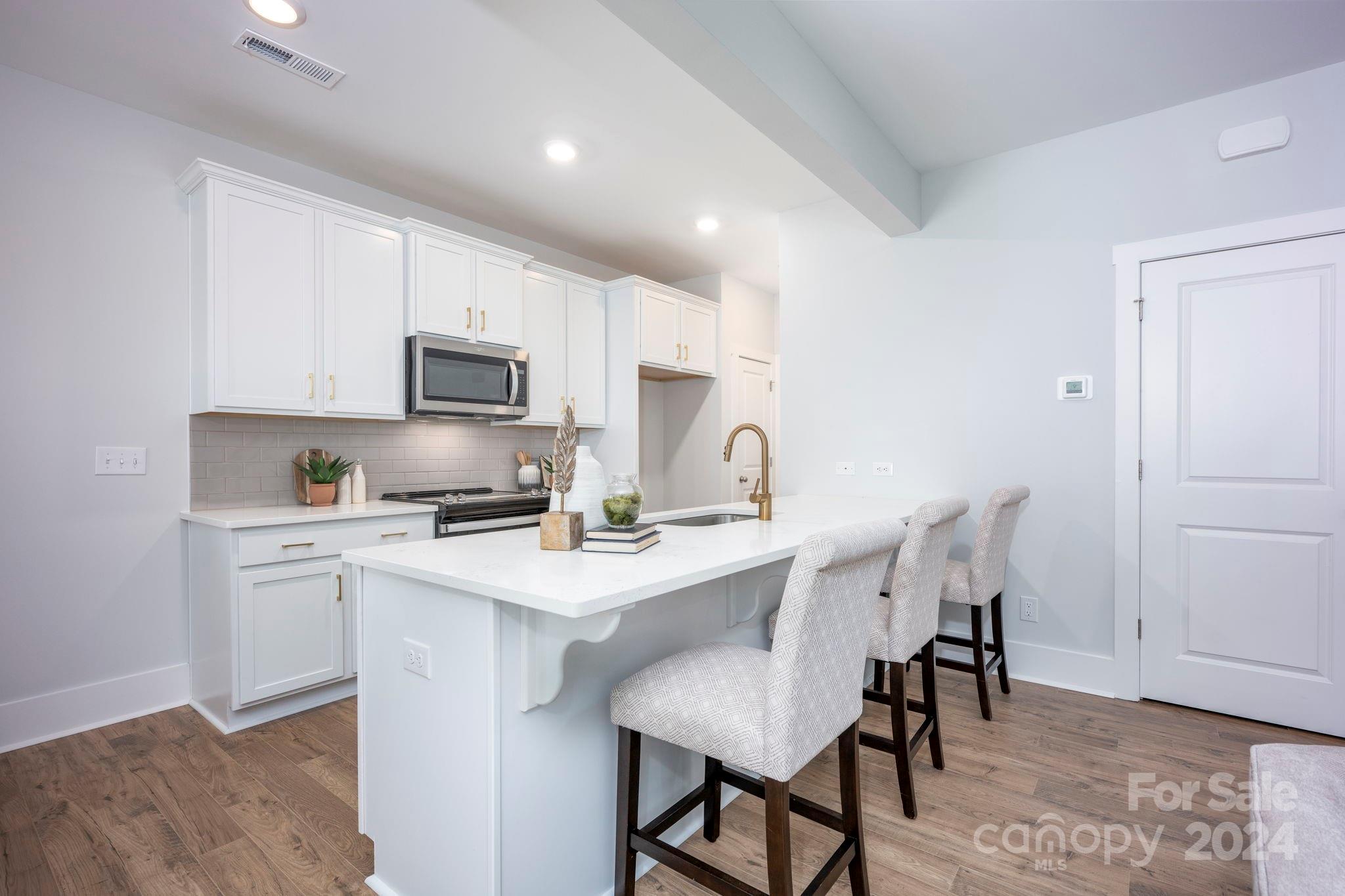 a kitchen with a dining table and chairs