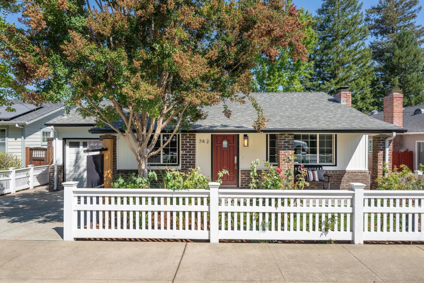 a front view of a house with a garden