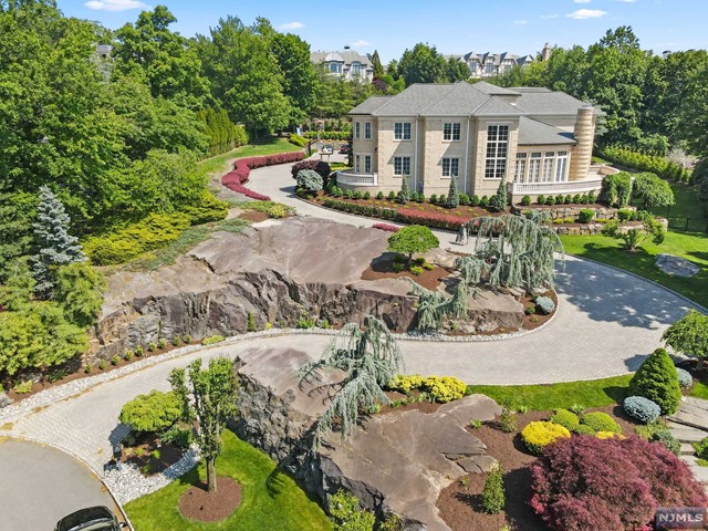 an aerial view of a house with yard patio and swimming pool