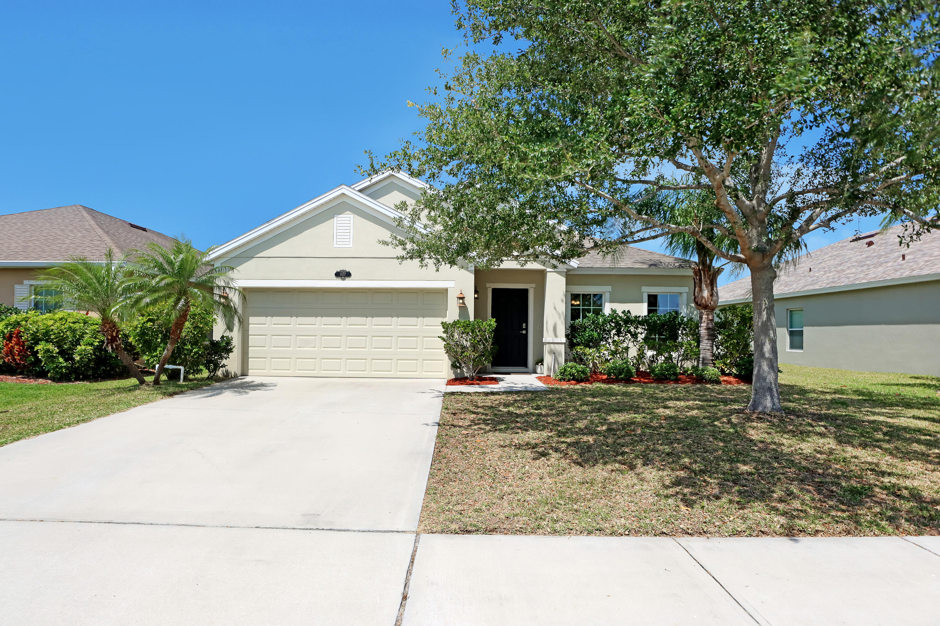 a front view of a house with a yard and garage