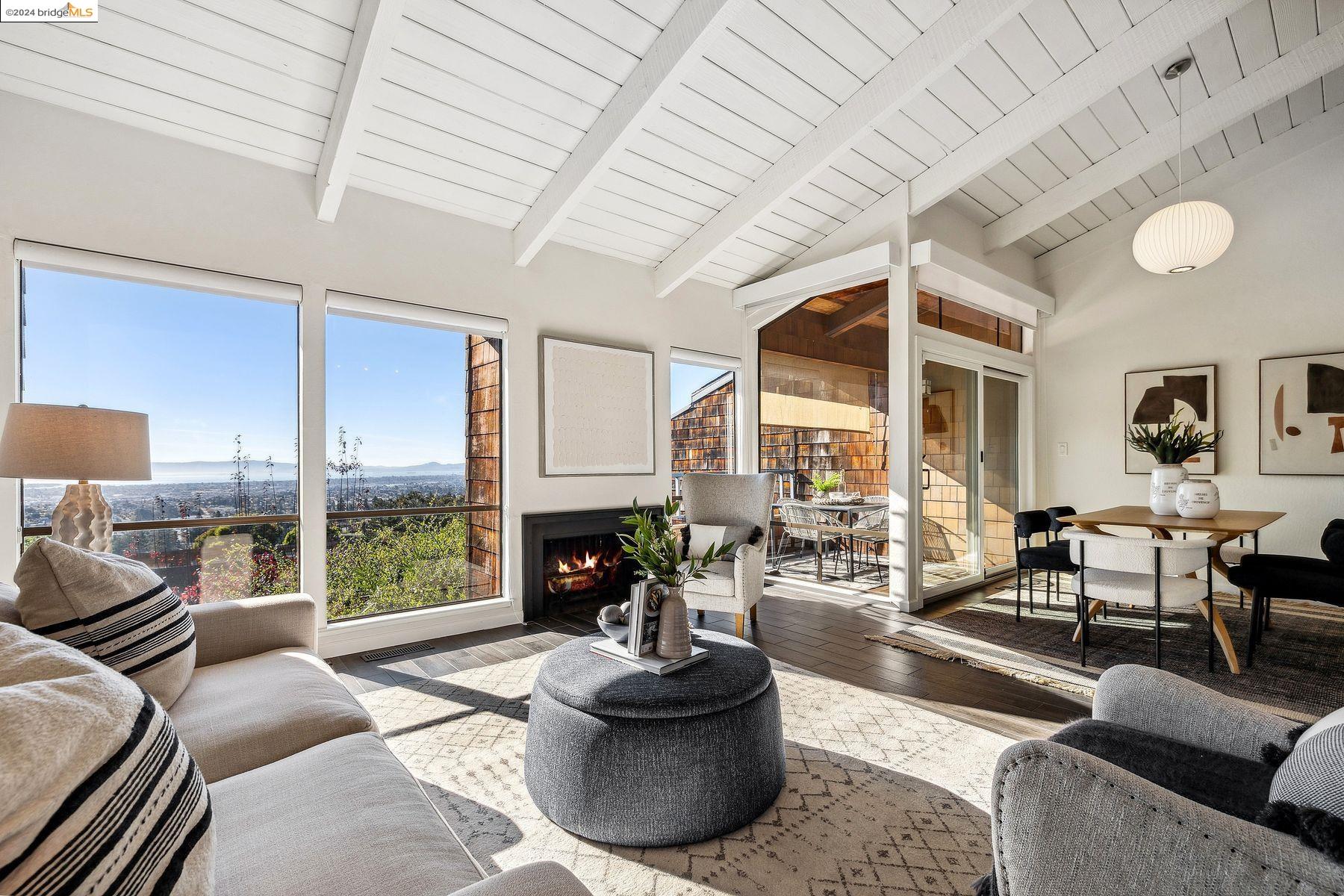 a living room with furniture fireplace and a large window