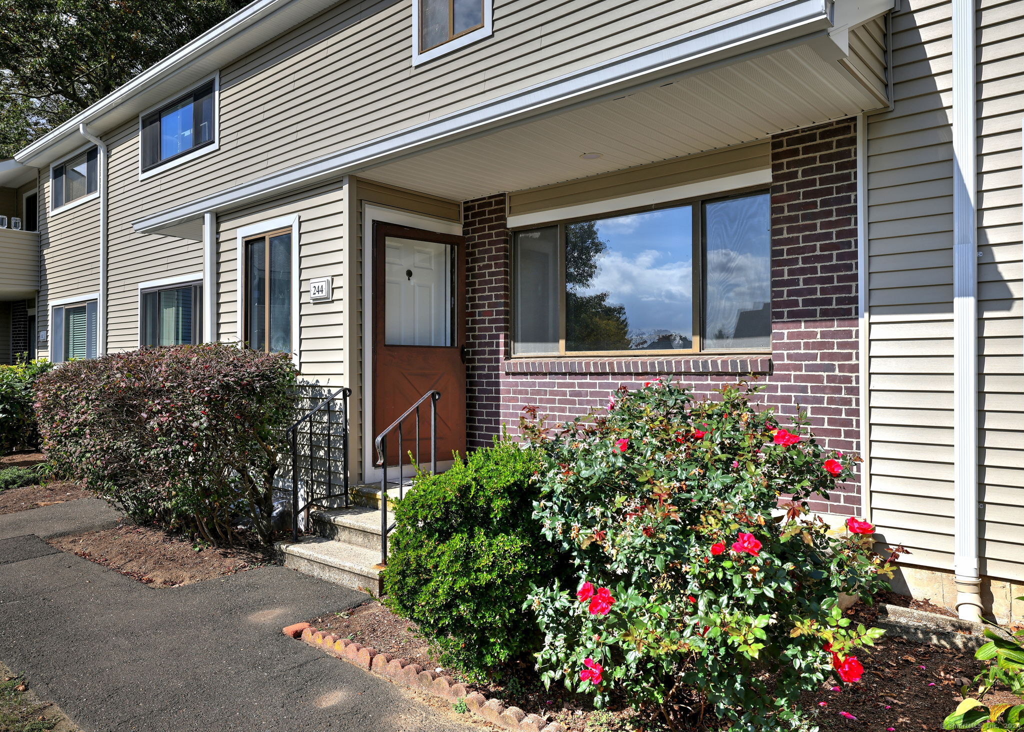 a view of a house with potted plants