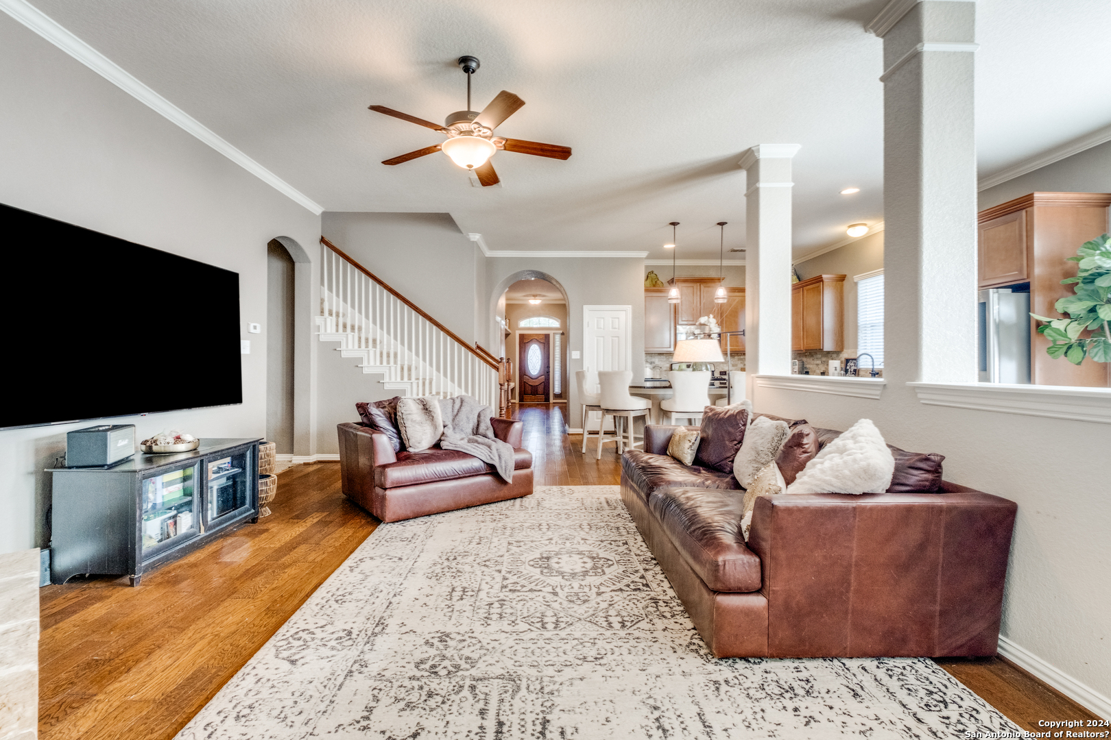 a living room with furniture and a flat screen tv