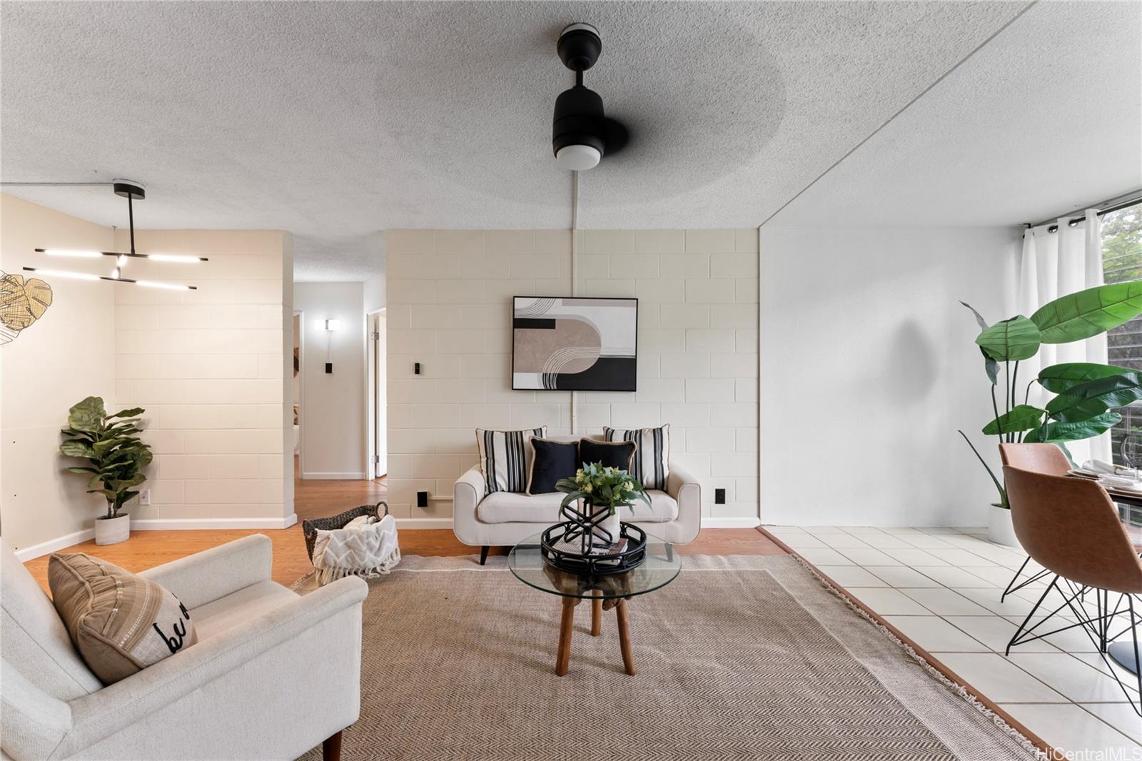 a living room with furniture and a potted plant