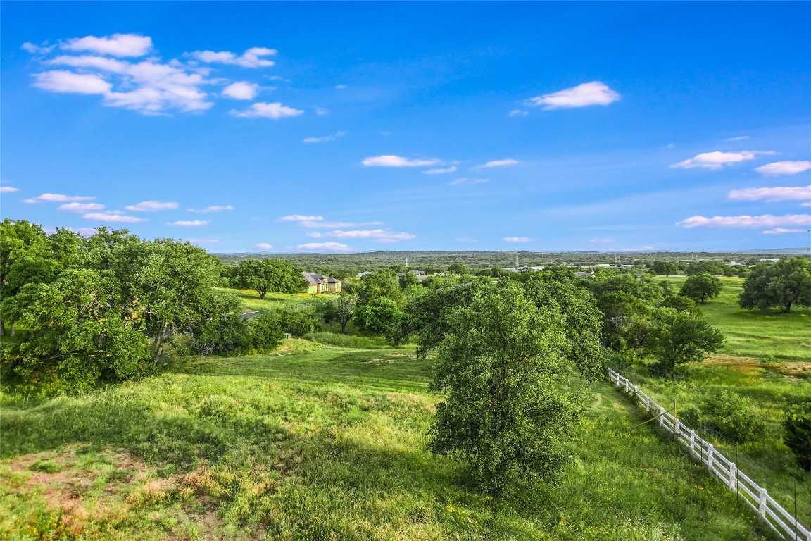 a view of a big yard with lots of green space