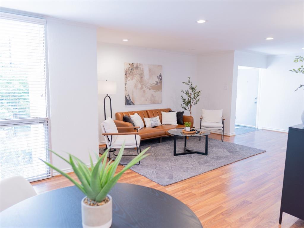 a living room with furniture and a potted plant