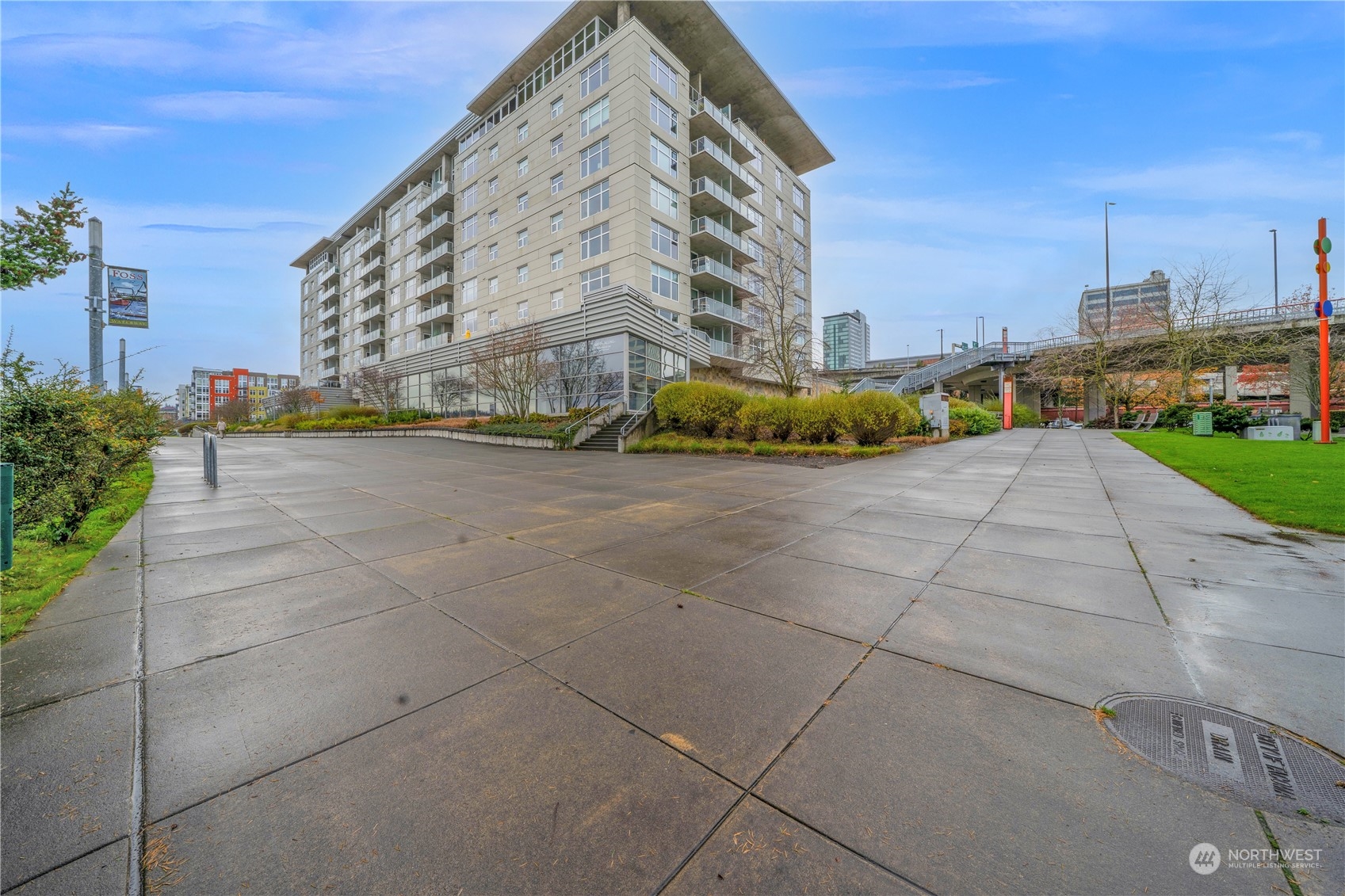 a view of a tall building next to a road