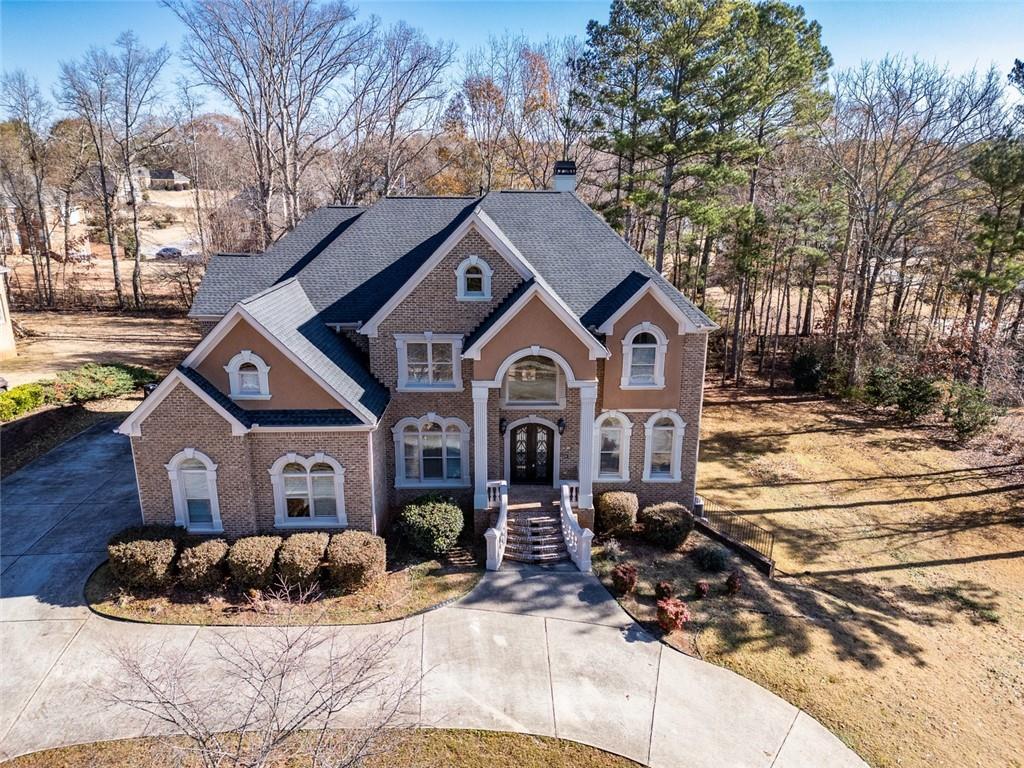 a front view of a house with a yard covered in snow