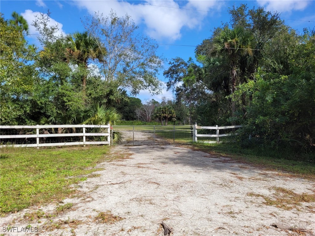 a view of a lake with wooden fence