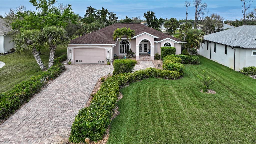 a front view of a house with a yard and trees