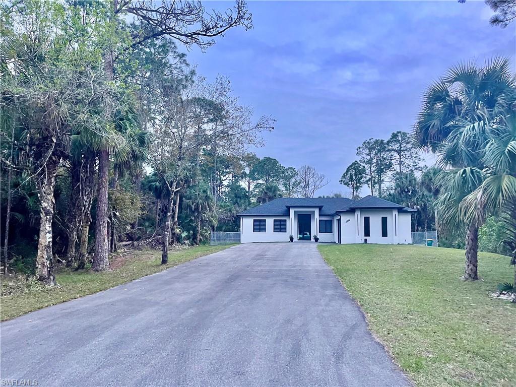 a view of a house with a yard