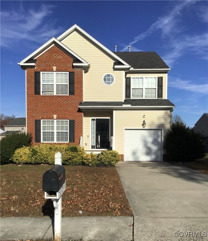 View of property featuring a garage