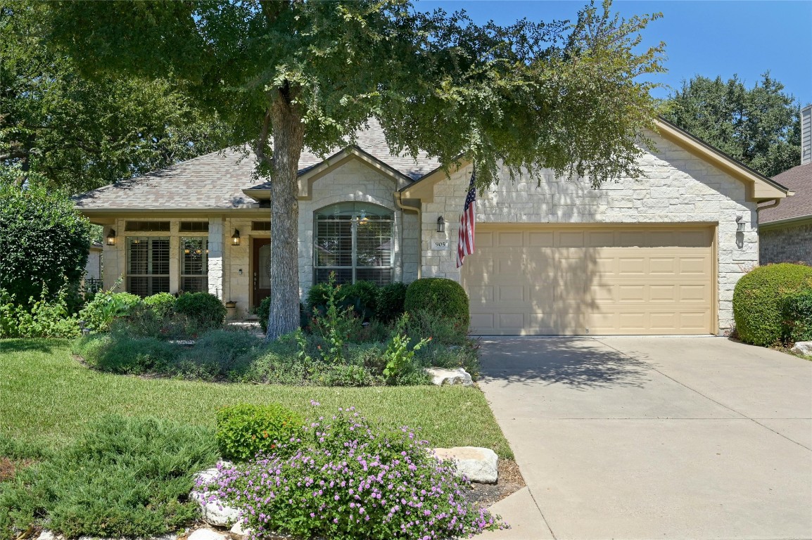 a front view of a house with a yard and trees