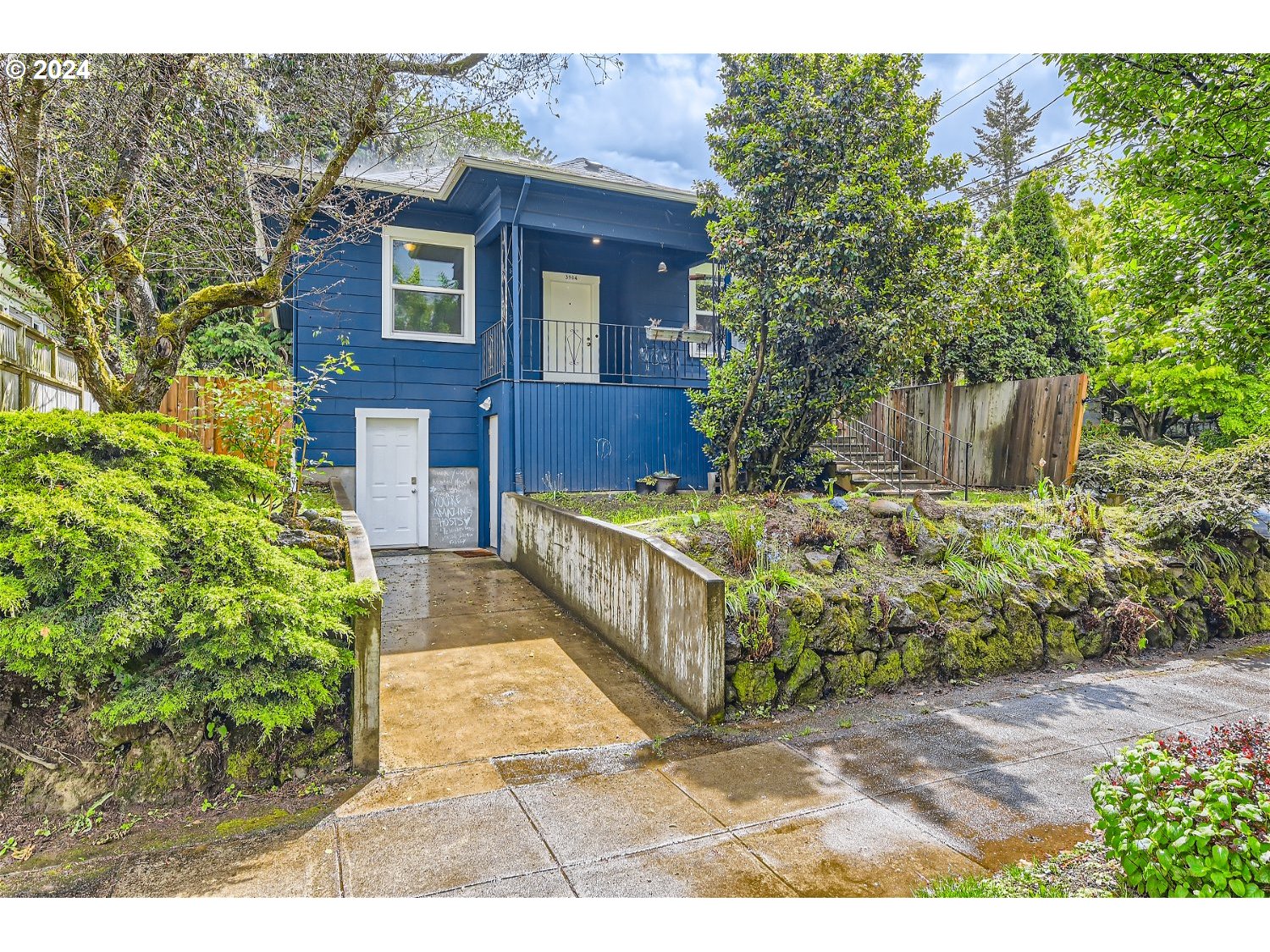 a view of a house with a yard and plants