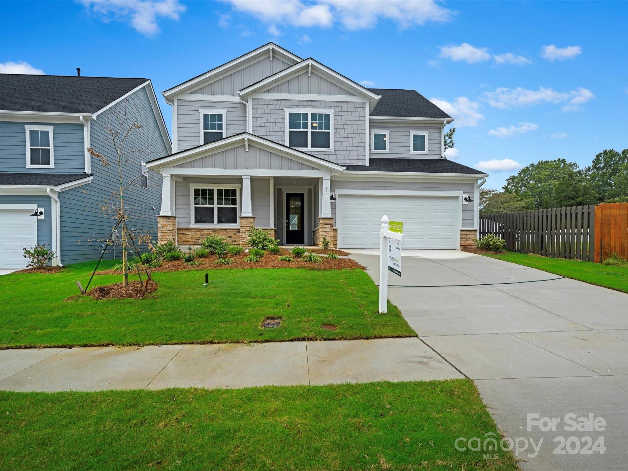 a front view of a house with a garden and yard