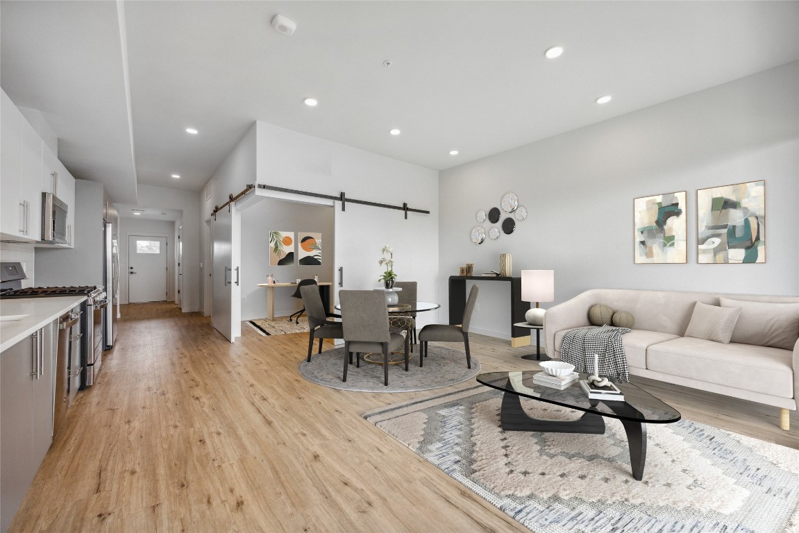 a living room with furniture and wooden floor