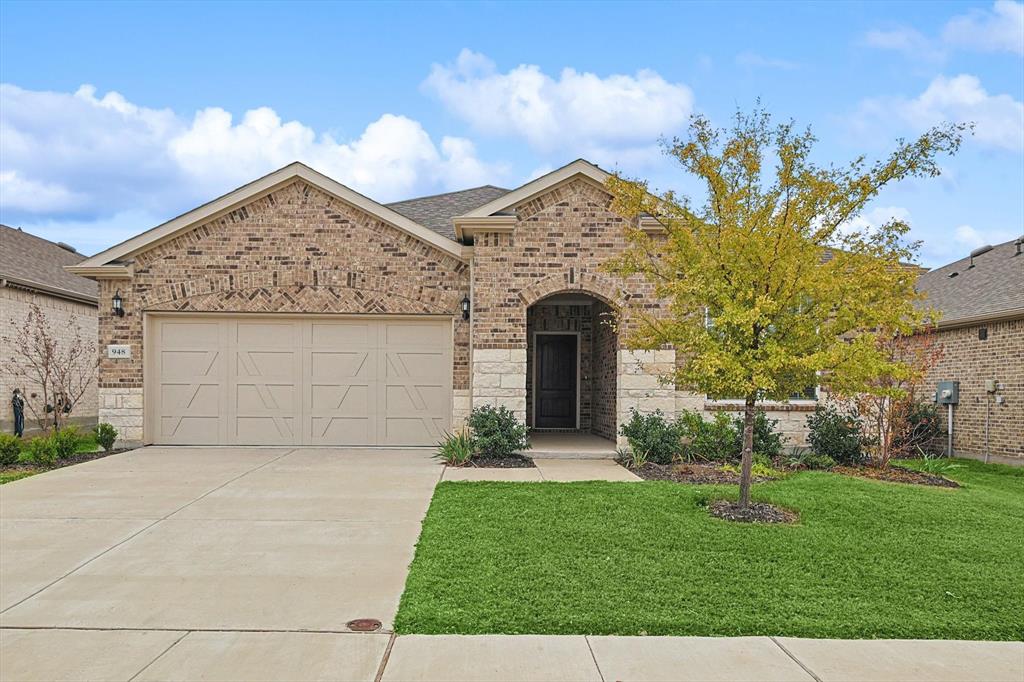 a front view of a house with a garden and yard