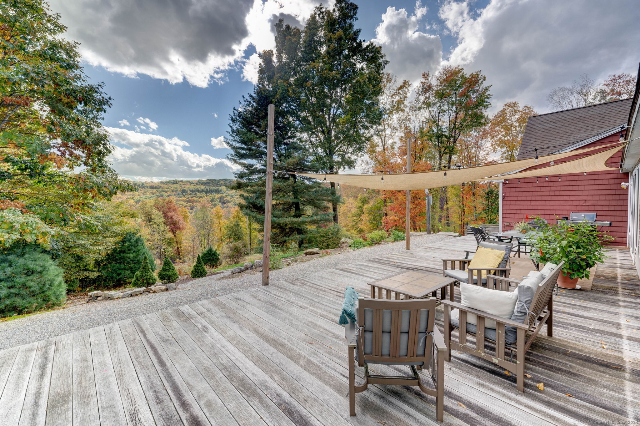 a view of a patio with table and chairs with wooden floor and fence