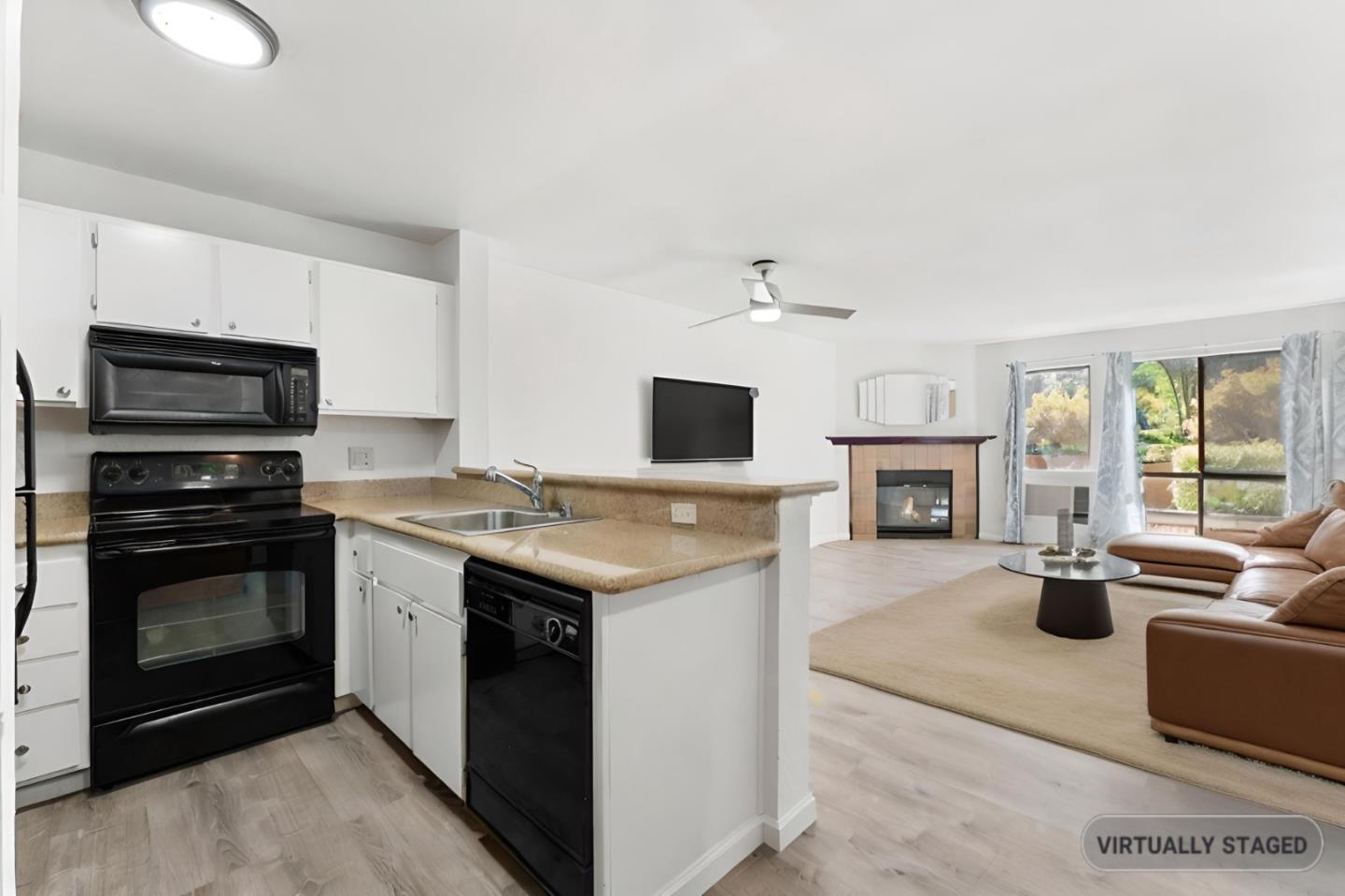 a kitchen with kitchen island stainless steel appliances a stove sink and microwave