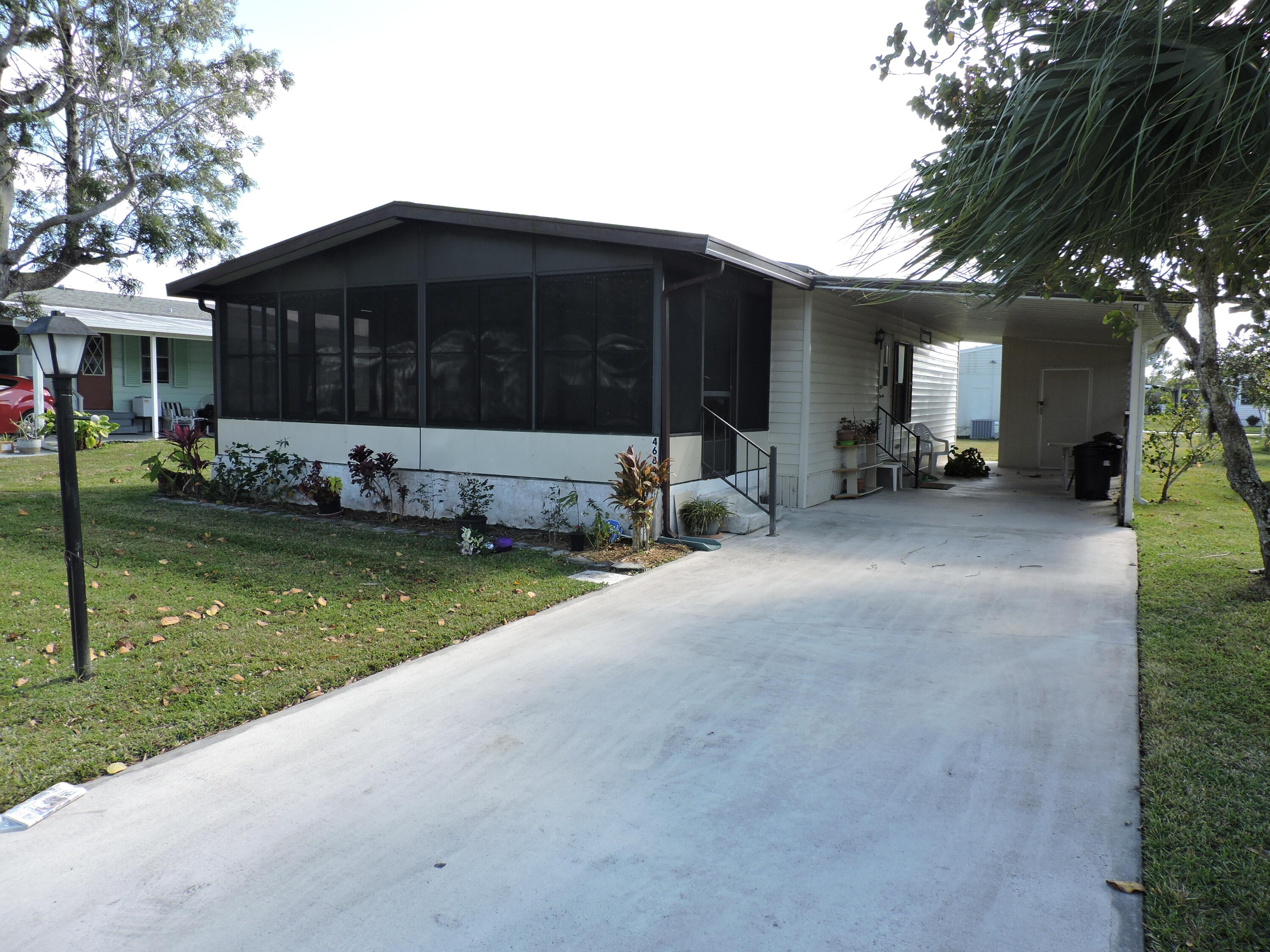 a view of a house with a yard and sitting area