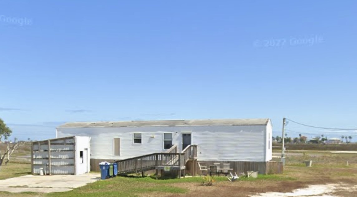 a view of a big building with yard in front of it