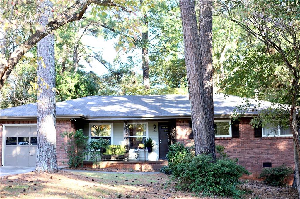 a view of a house with a tree and front view