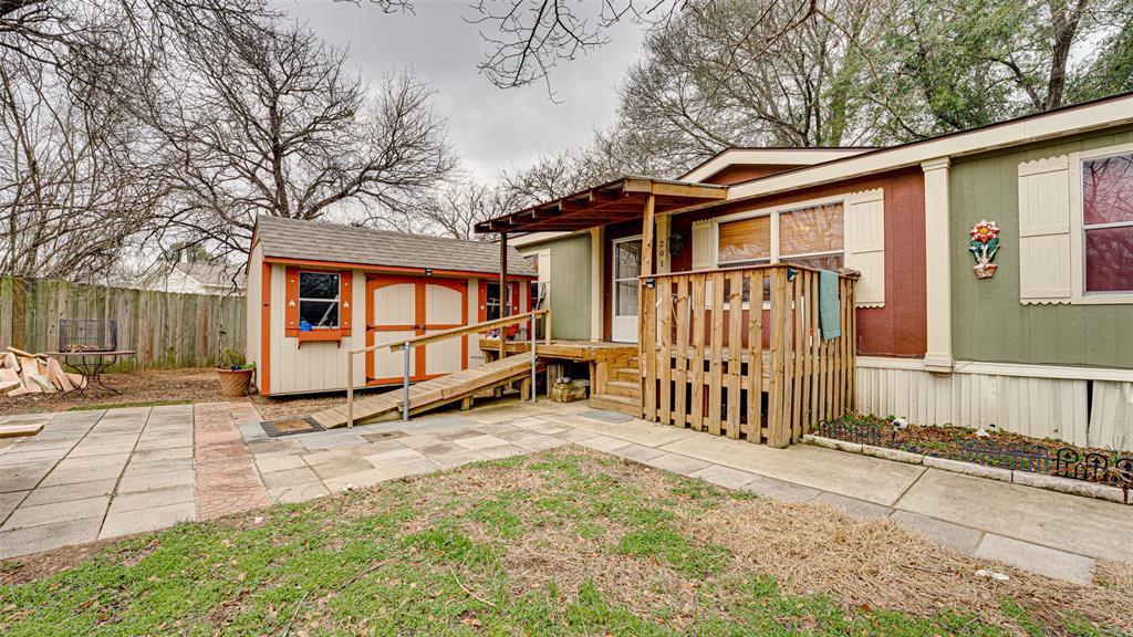 a view of a house with a yard and wooden fence