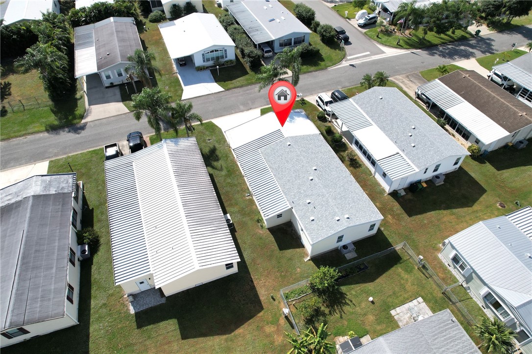 an aerial view of a house with a yard