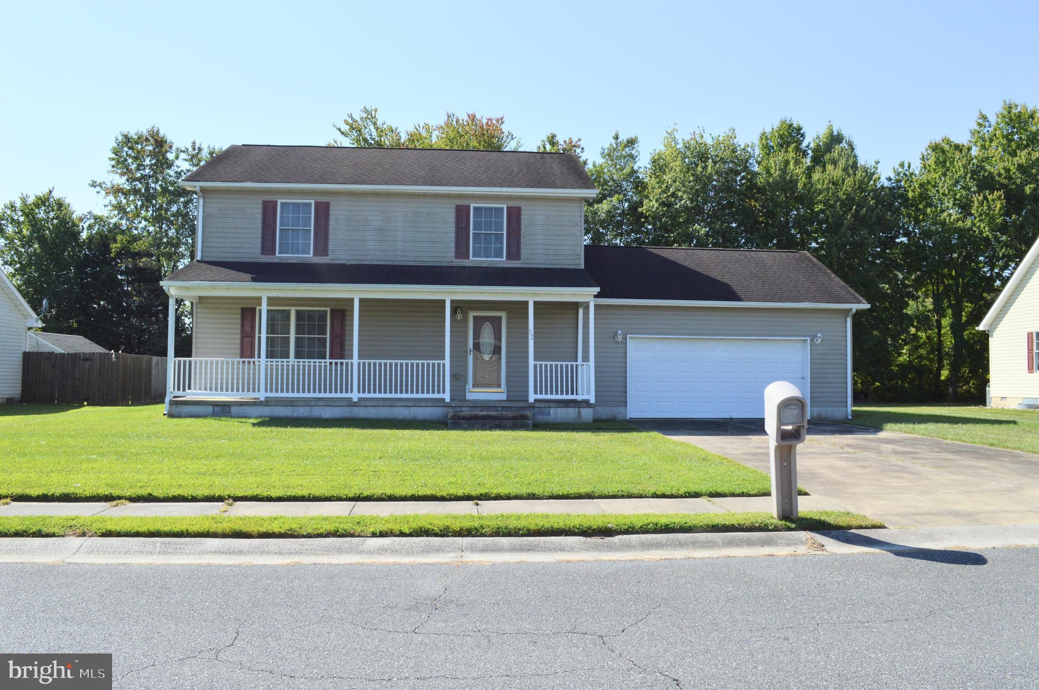 a house with a yard and a large parking space