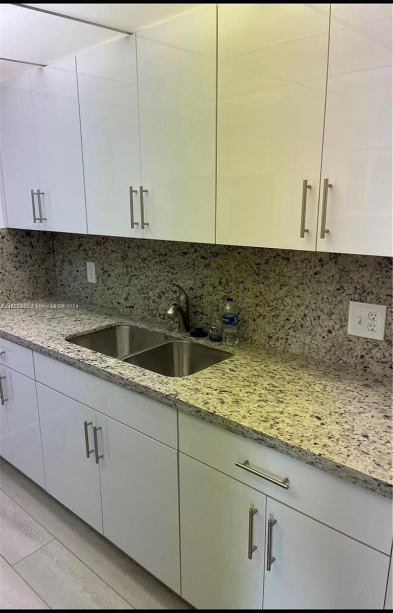 a kitchen with a sink and cabinets